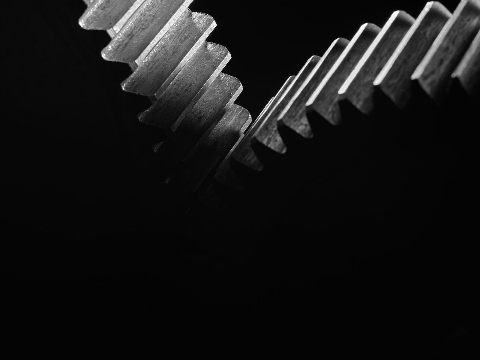 Two machined gears meeting tooth to tooth